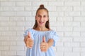 Cheerful young girl giving thumbs-up Royalty Free Stock Photo