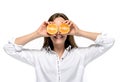 Cheerful young girl holding two slices of orange at her face. Isolated on white wall Royalty Free Stock Photo