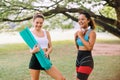 Cheerful young girl holding yoga mats and talking together at outdoor in the morning,Happy and smiling,Positive thinking