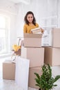 Cheerful young girl packing books and smiling Royalty Free Stock Photo