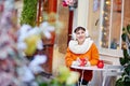 Cheerful young girl in Parisian outdoor cafe