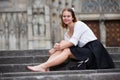 cheerful young girl sitting on stone steps Royalty Free Stock Photo