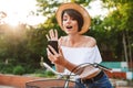 Cheerful young girl in summer clothes riding bicycle Royalty Free Stock Photo