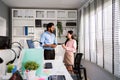 The cheerful young group of Asian businessmen in casual with Indian man and Asian businesswoman colleagues discussing. Royalty Free Stock Photo