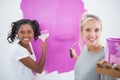 Cheerful young housemates painting wall pink Royalty Free Stock Photo