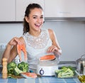 Woman steaming salmon and vegetables. Royalty Free Stock Photo