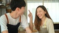 Cheerful young husband and wife have fun together in kitchen, enjoying spending free weekend time together at home Royalty Free Stock Photo