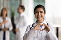 Cheerful young Indian doctor woman making hand heart Royalty Free Stock Photo