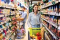 Casual woman shopping in supermarket with trolley cart Royalty Free Stock Photo