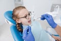 Cheerful young lady sitting in dentists chair Royalty Free Stock Photo