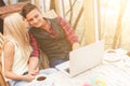 Cheerful young lovers are resting in cafeteria Royalty Free Stock Photo