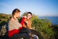 Cheerful young lovers, sunset over the sea, mountains, fun / sty Royalty Free Stock Photo