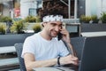 Cheerful young male freelancer satisfied with getting good news talking on mobile phone, happy hipster guy excited with completed Royalty Free Stock Photo