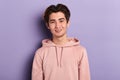 Cheerful young male model in punk hoodie posing to the camera Royalty Free Stock Photo