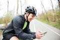 Cheerful young man with bicycle using mobile phone Royalty Free Stock Photo