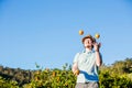 Cheerful young man juggling oranges on citrus farm Royalty Free Stock Photo