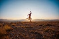 cheerful young man jumps and rejoices against the backdrop of mountains. long awaited vacation. Active tourist enjoying travel in Royalty Free Stock Photo