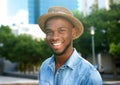 Cheerful young man laughing outdoors with hat Royalty Free Stock Photo