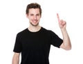 Cheerful young man pointing towards something interesting Royalty Free Stock Photo