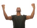 Cheerful young man shouting with arms raised in success