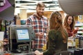 Cheerful young man standing in supermarket shop