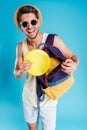Cheerful young man taking frisbee disk from backpack Royalty Free Stock Photo