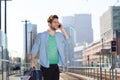 Cheerful young man at train station platform with mobile phone Royalty Free Stock Photo