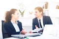 Cheerful young man and woman coworkers talking in firm office Royalty Free Stock Photo