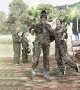 Cheerful young man and woman in full paintball gear having fun a Royalty Free Stock Photo