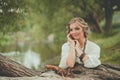 Cheerful young model woman in boho style dress at the lake outdoor Royalty Free Stock Photo