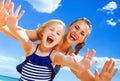 Cheerful young mother and child on seashore having fun time