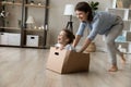 Cheerful young mother playing with little daughter at home. Royalty Free Stock Photo