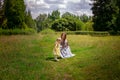 Cheerful young mother plays with her little daughter at the green meadow Royalty Free Stock Photo