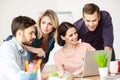 Cheerful young office workers are discussing a project