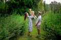 Cheerful young parents playing with their little baby girl at the green garden Royalty Free Stock Photo