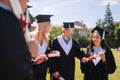 Cheerful young people graduating from the university.