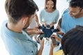 Cheerful young people using their smartphones