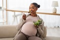 Cheerful young pregnant african american woman eating salad Royalty Free Stock Photo