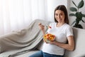 Cheerful Young Pregnant Woman Enjoying Fresh Vegetable Salad At Home Royalty Free Stock Photo