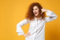 Cheerful young redhead woman girl in casual white shirt posing isolated on yellow orange background in studio. People Royalty Free Stock Photo