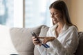 Cheerful young bank client woman using online service for payment Royalty Free Stock Photo