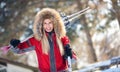 Cheerful young skier with skis and poles