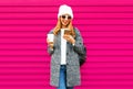 Cheerful young smiling woman with phone holding coffee cup Royalty Free Stock Photo