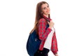 Cheerful young student girl with backpack looking away and smiling isolated on white background. student years concept Royalty Free Stock Photo