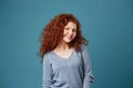 Cheerful young student girl with wavy red hair and freckles brightfully smiling showing her teeth, posing for graduation Royalty Free Stock Photo