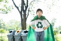 Cheerful young superhero boy with cape and recycle symbol. Gyre
