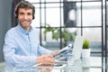 Cheerful young support phone male operator in headset, at workplace while using computer, help service and client Royalty Free Stock Photo