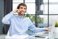 Cheerful young support phone male operator in headset, at workplace while using computer, help service and client Royalty Free Stock Photo