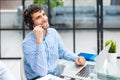 Cheerful young support phone male operator in headset, at workplace while using computer, help service and client Royalty Free Stock Photo