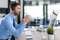 Cheerful young support phone male operator in headset, at workplace while using computer, help service and client consulting call Royalty Free Stock Photo